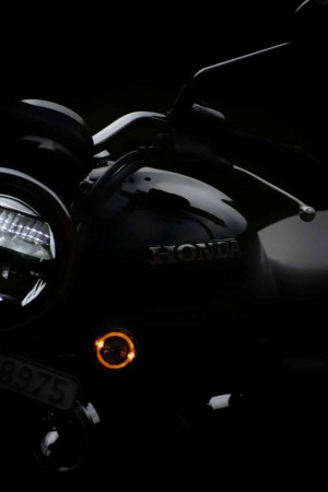 Close-up of a black Honda Rebel motorcycle with a glowing turn signal.
