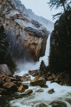 A majestic waterfall cascading down granite cliffs in Yosemite National Park.