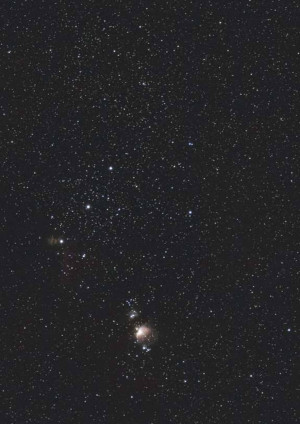 A stunning long-exposure photograph of the Milky Way galaxy with visible stars and nebulae.