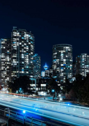 City skyline of Vancouver at night with light trails from traffic
