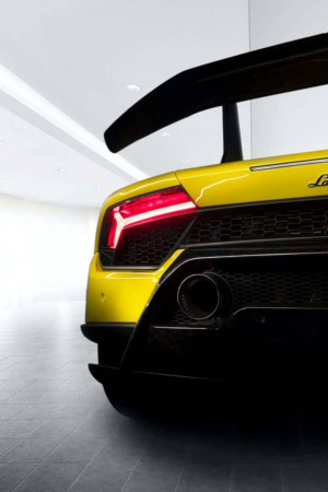 Rear view of a bright yellow Lamborghini sports car with a large spoiler