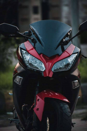Front view of a red and black sportbike with a focused headlight.