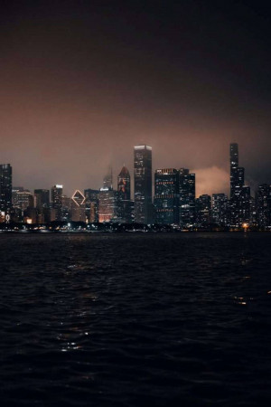 Night view of Hong Kong cityscape with illuminated skyscrapers over water
