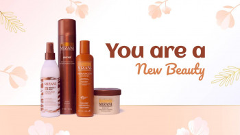 Mizani haircare products arranged with floral accents and text 'You are a New Beauty'
