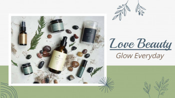 Assortment of natural beauty products including lotions, oils, and candles on a marble surface.