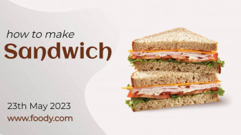 Stacked sandwich with ham, cheese, lettuce, and tomato