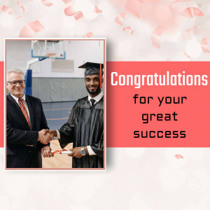 A man in a graduation cap and gown shaking hands with a man in a suit, with confetti falling around them.