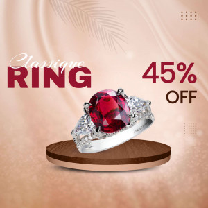 Silver ring with a large red gemstone and diamond accents on a wooden pedestal