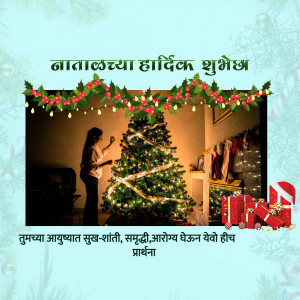 A woman decorating a Christmas tree with festive decorations and gifts.