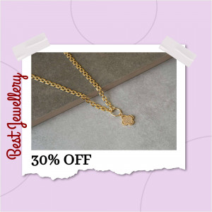Close-up of a gold clover pendant necklace on a neutral background with a promotional offer.