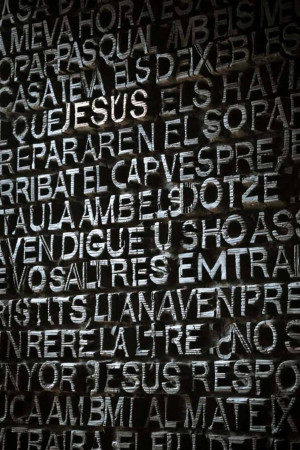 Close-up of an old stone wall with carved Latin text.