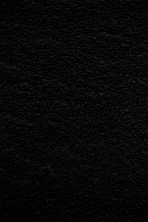 Close-up of a dark, grainy textured surface