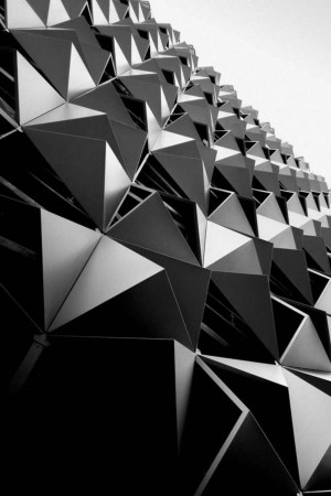 Close-up of a modern building facade with triangular panels