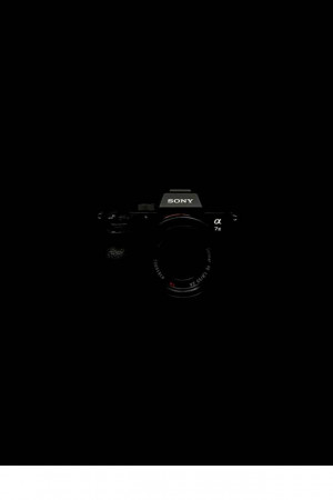 Close-up of a black Sony Alpha 7S camera against a black background