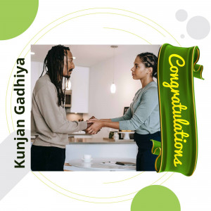 Two people shaking hands with a 'Congratulations' banner.