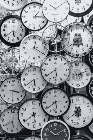 A collection of vintage clocks hanging on a wall.