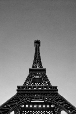Black and white photograph of the Eiffel Tower pointing upwards.