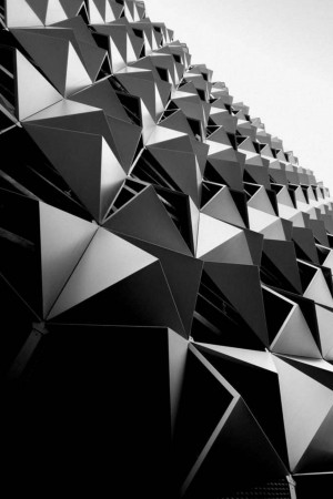 Close-up of a modern building facade with geometric triangular panels