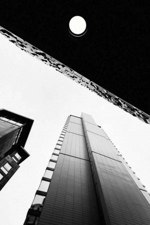 Black and white photograph of skyscrapers viewed from a low angle