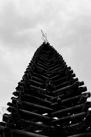 Black and white image of the iconic prang (spire) of Wat Arun temple in Bangkok, Thailand.