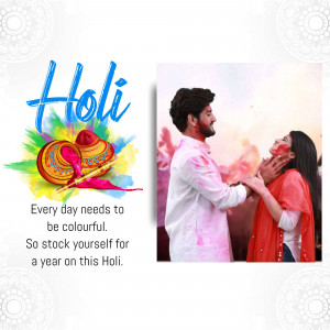 A couple celebrating Holi, covered in colorful powder.