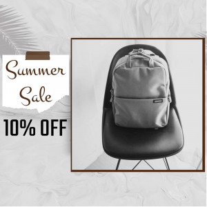 Gray backpack on a black chair with a summer sale promotion