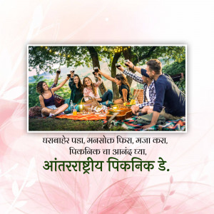 Group of friends toasting with drinks during a picnic in a park