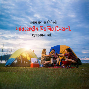 A group of friends enjoying a picnic near their tents at a lakeside during sunset.