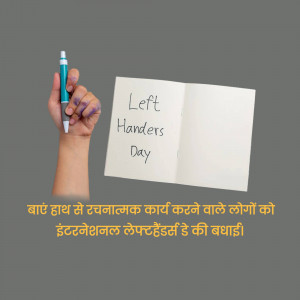 Hand writing 'Left Handers Day' on a notebook