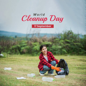 A young woman volunteering to clean up trash on World Cleanup Day.