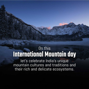 Snow-capped mountains reflected in a lake with text celebrating International Mountain Day