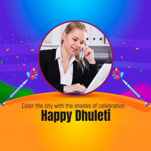 Woman working on laptop and talking on the phone with a festive Dhuleti background.