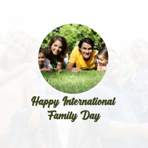 Family lying on grass with text 'Happy International Family Day'