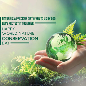 A glass globe depicting Earth held in a hand with lush green foliage, promoting nature conservation.