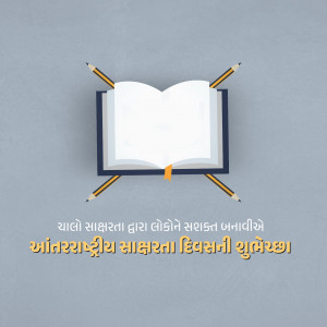 Open book with pencils and Gujarati text wishing International Literacy Day