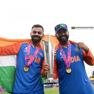 Virat Kohli and Ravindra Jadeja celebrating with the World Test Championship trophy, draped in the Indian flag.