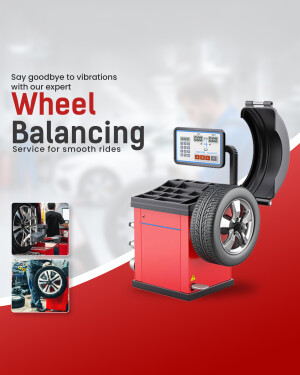 Wheel balancing machine with a tire and technician working on a car wheel