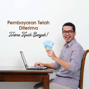 Man smiling and holding money with a laptop.