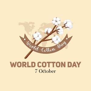 Illustration of cotton branches and a ribbon with 'World Cotton Day' text over a world map background.
