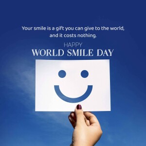 Hand holding a paper with a smiley face for World Smile Day