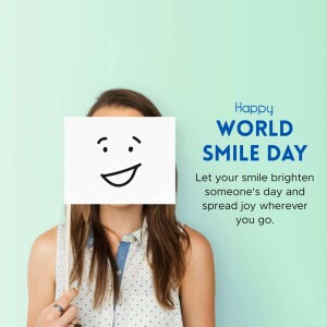 Woman holding a sign with a smiling face for World Smile Day