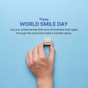 A hand holding a wooden block with a smiley face on it, celebrating World Smile Day.