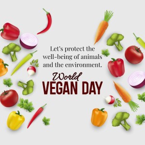 A colorful arrangement of fresh vegetables and fruits with the text 'World Vegan Day' and a message about protecting animal and environmental well-being.