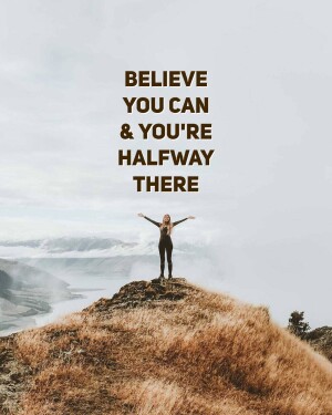 Woman standing on a mountaintop with arms outstretched, motivational quote 'Believe you can & you're halfway there'
