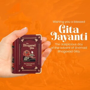 A hand holding a miniature Bhagavad Gita book against an orange background with text wishing a blessed Gita Jayanti.