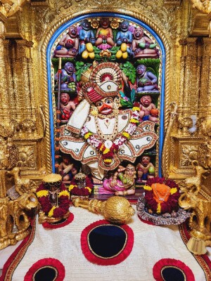 Close-up of a beautifully decorated Hanuman idol within a temple setting.