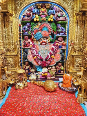 Close-up of a beautifully decorated Hanuman deity in a temple
