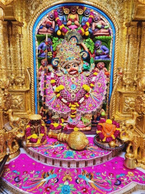 Intricate golden frame surrounding a vibrant depiction of Hanuman Ji