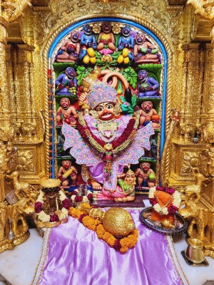 Close-up of a beautifully decorated Hanuman idol in a temple setting.