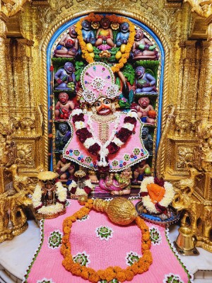 Close-up of a beautifully decorated Hanuman idol in a temple setting.